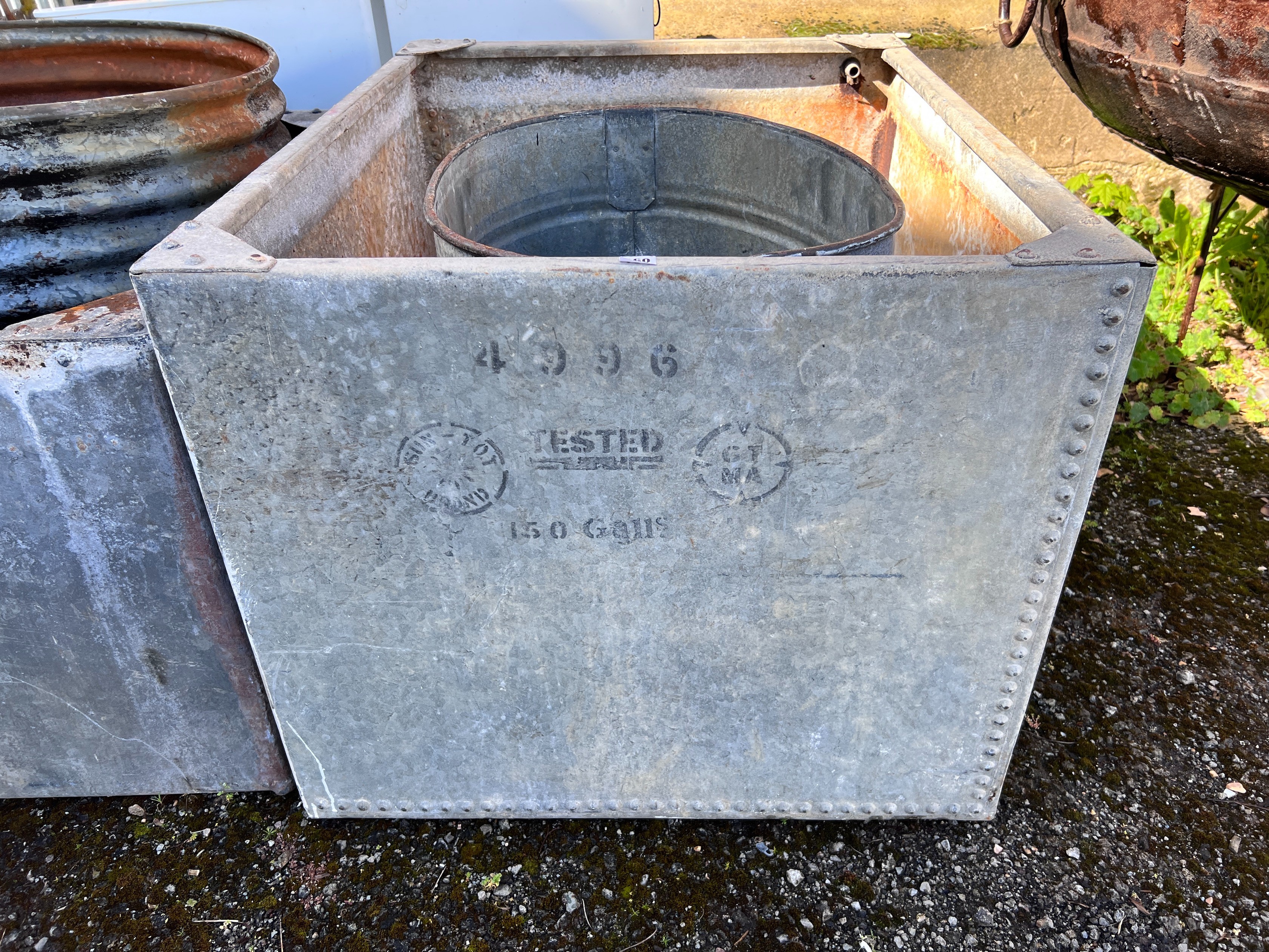 A large rectangular galvanised tank, width 107cm, depth 84cm, height 72cm together with an oval galvanised tank *Please note the sale commences at 9am.